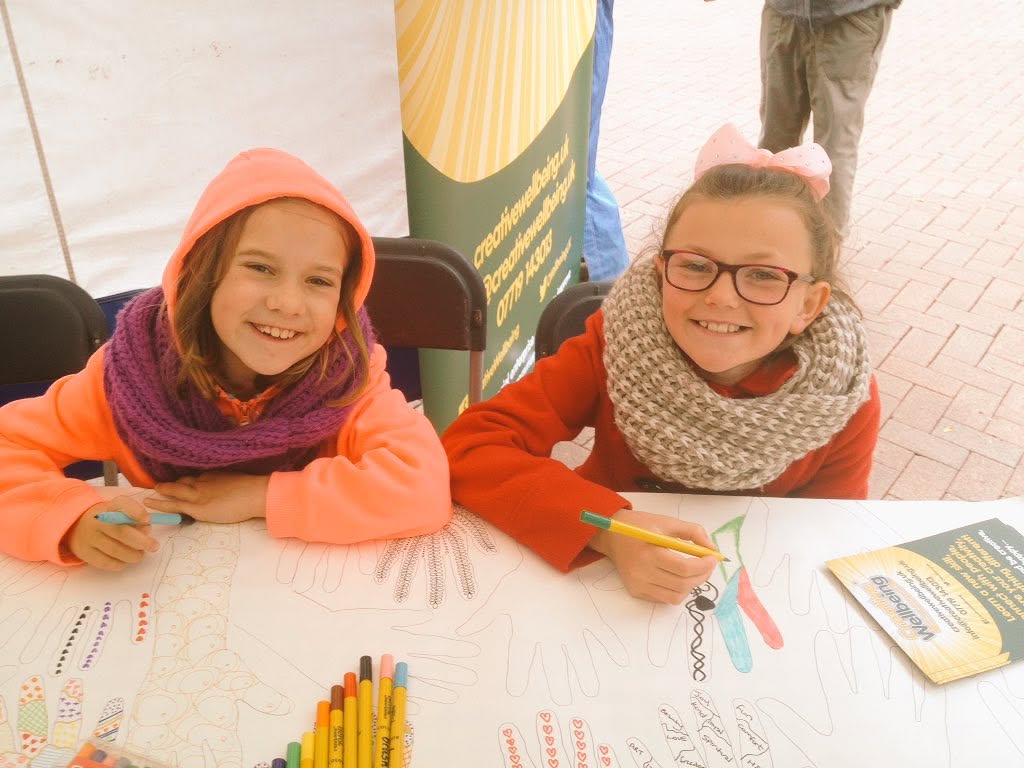 Two smiling girls enjoying their drawings in Carlisle City Centre