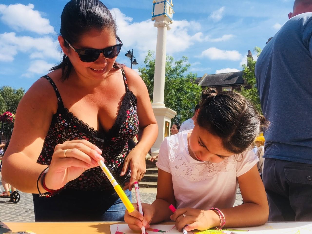 Mother and daughter enjoying drawing in the sunshine at a Creative Wellbeing event in Cartlisle city centre