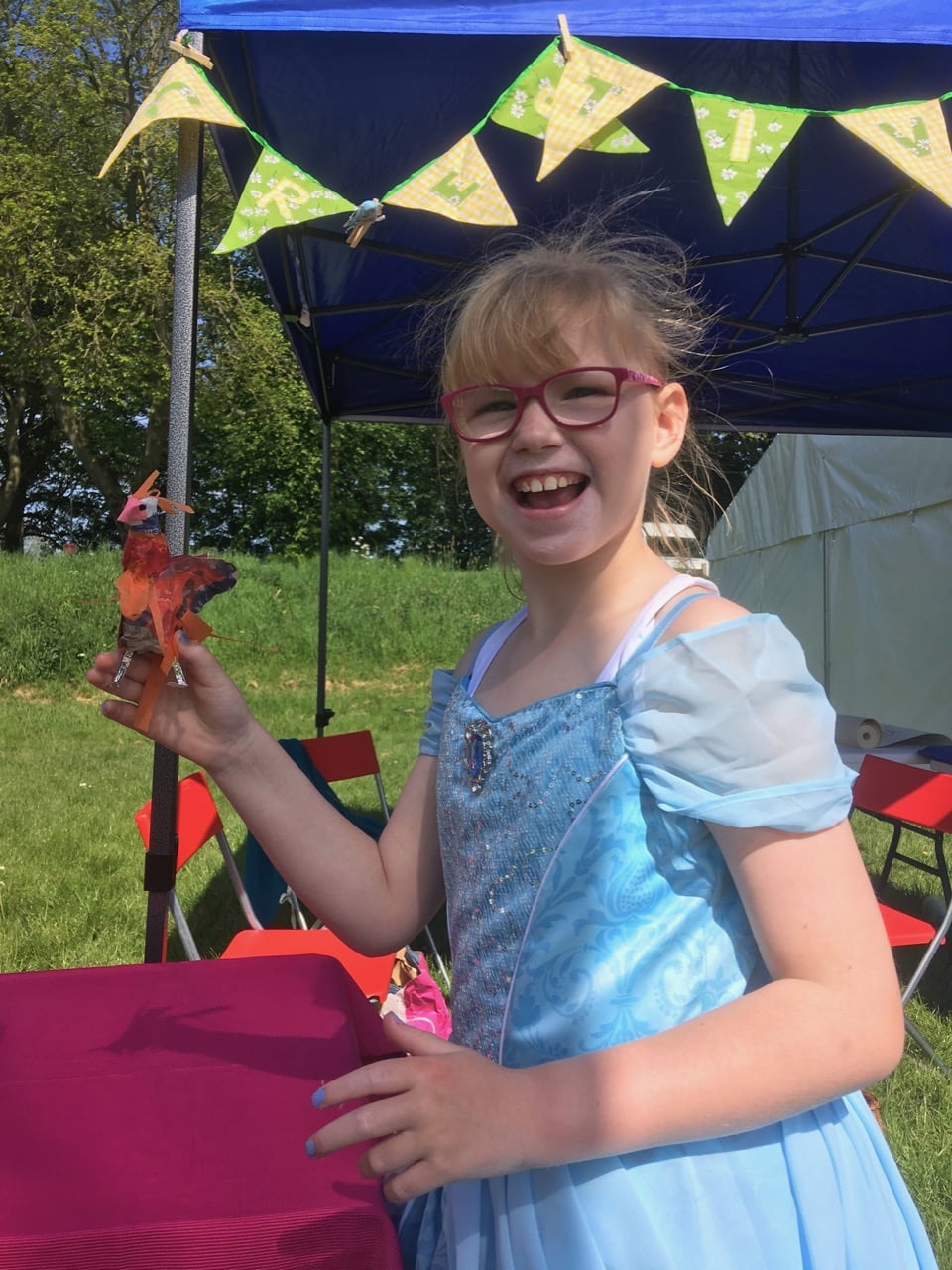 Girl enjoying the sunshine at a Creative Wellbeing event in Cartlisle Bitts Park