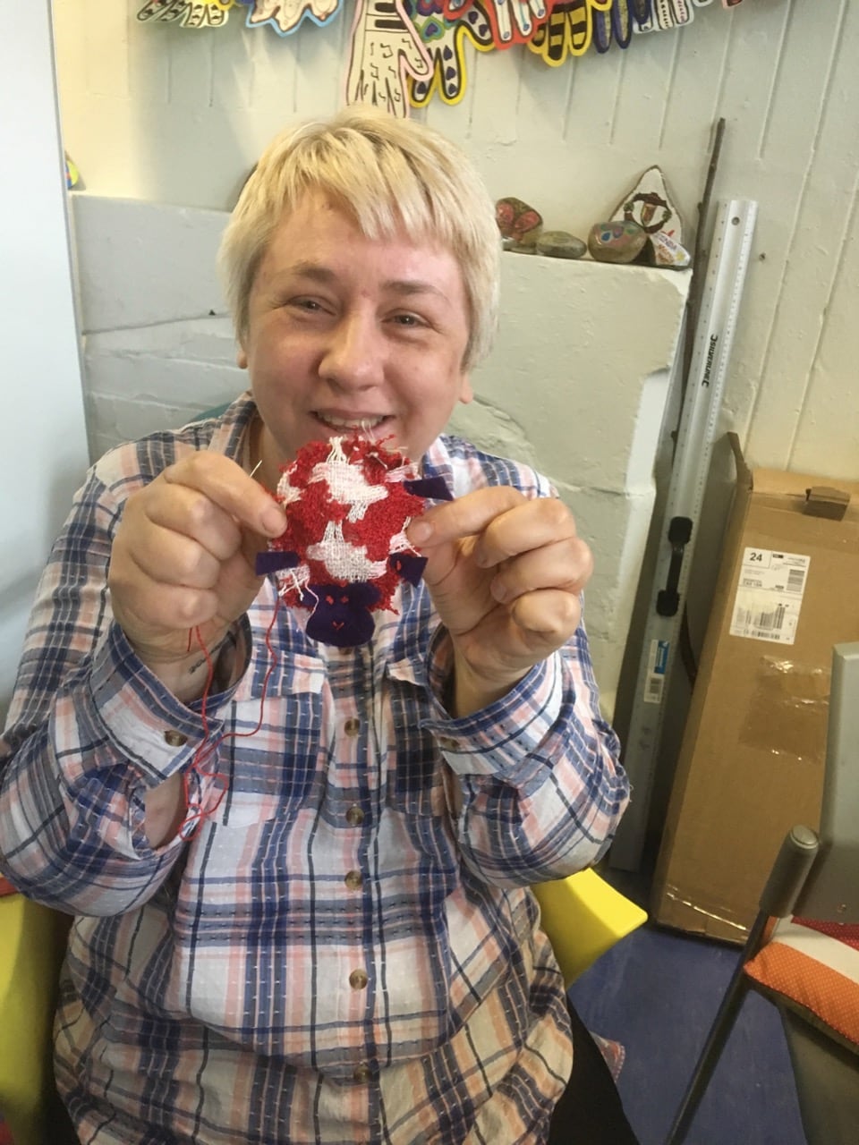 Participant showing off her knitted character creation